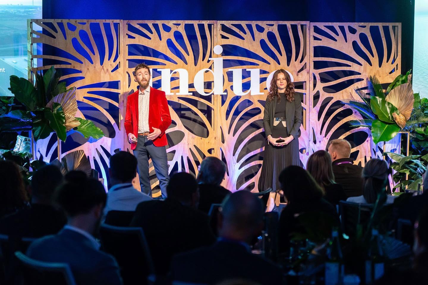 Rebecca Maklad and Tāne Hunter presenting on stage
